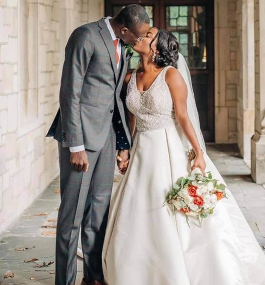 Сouple wearing a white gown and a gray suit